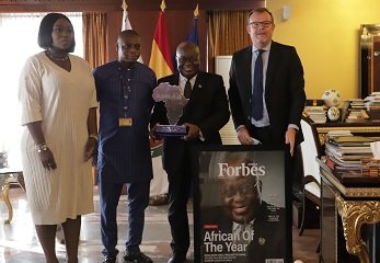 President Akufo-Addo (second from right), with Mr Frederic Van Vyver (right)with Ms Peace Hyde (left), Founder of Aim Higher Africa after presenting the Fobrbes Africa award