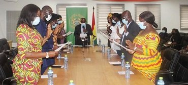 • Kwaku Agyeman-Manu (middle) swearing in the Nurses and Midwifery Council board