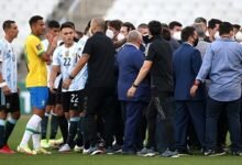 Health officials storm the pitch to halt the game owing to Covid-19 concerns