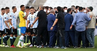 Health officials storm the pitch to halt the game owing to Covid-19 concerns