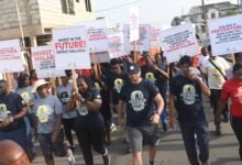 Healthwalk----Some of the participants with placards matching on the street.Photo Geoffrey Buta