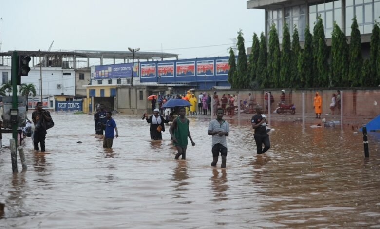 Some people wading through the flood