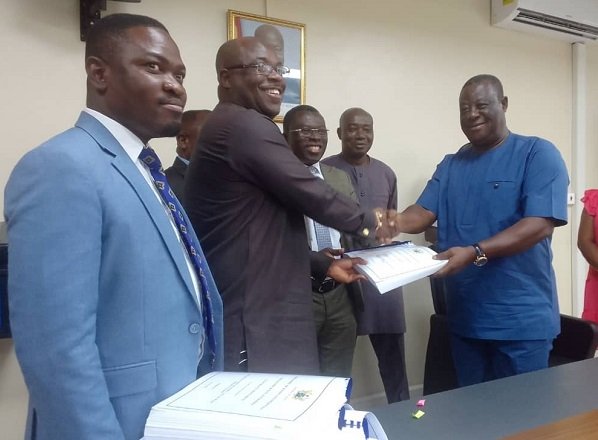 • Mr Amoako–Atta (Second Right) exchanging the signed documents with Mr Eric Seddy Kutortse, Chairman of First Sky