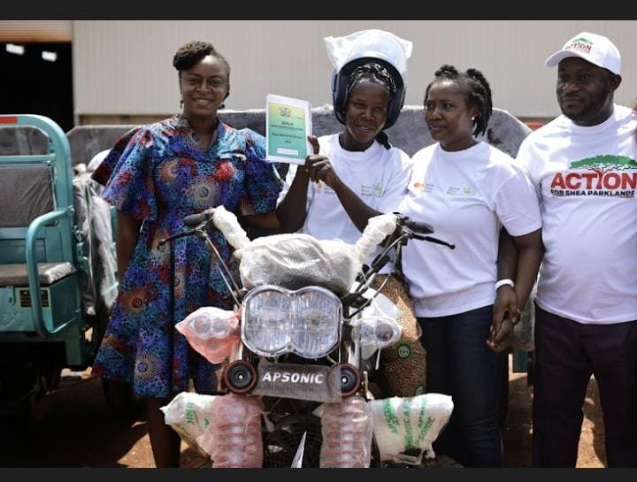 • Rosy Fynn (left), and Aaron Adu (right), president of CSA, presenting tricycles to the shea collectors at the launch
