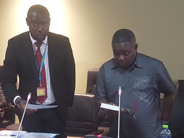 Mr Obiri-Yeboah, right, taking the oath before testifying