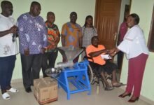 • Madam Sowah (right) presenting the amount and machine to Mr Adarkwah Photo: Victor A. Buxton