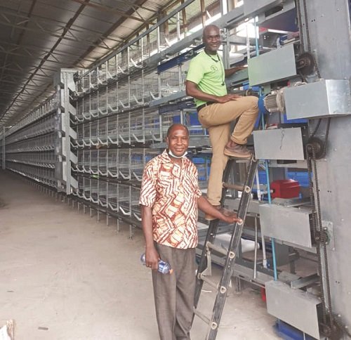 • Reverend standing by Ing Abdul-Kadr Shaibu installing the multi-dollar five-tier cage system