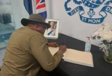 Nii Ashietey signing the book of condolence