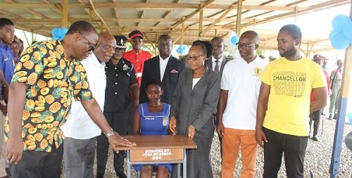 • Members of the year group presenting the desks to the management of the school