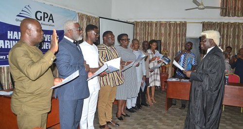• Justice Stephen Oppong (right) swearing in the new executive of GPA Photo: Victor A. Buxton