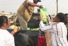 Mr Nasam distributing items to the beneficiaries