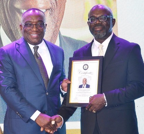 • Mr Sam Ato Gaisie (right), Founder President of Entrepreneurs Foundation, presenting an award to Mr Kwesi Agyeman Busia (second from right), the outstanding CEO of the year Photo: Vincent Dzatse