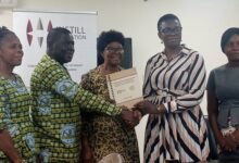 : Rev Ayembilla (second left) exchanging the MoU with Ms Osei (second right).