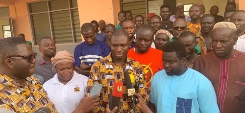 Dr Eduah (inset) addressing journalists after handing over the building