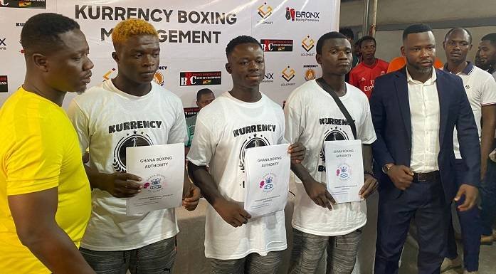 Coach Carl Lokko (left) and Mr Aboagye (right) with the three new signees in the middle