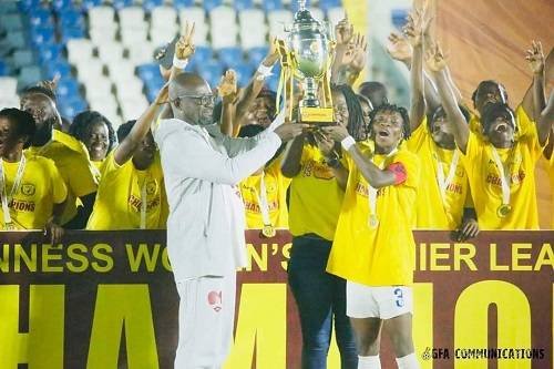 FA President Kurt Okraku presents a trophy to the skipper of the Ampem Darkoa side