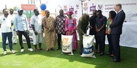 • Mr Acheampong (fifth from right) with Mr Valk (extreme right) inspecting some of the fertilisers