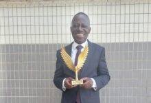 Mr Osei-Prempeh displaying the award