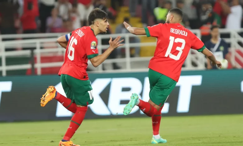 Morocco players celebrate the late win over Guinea in the opening match
