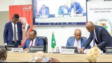 Mr Akinyemi (left) and Mr Mene signing the agreement
