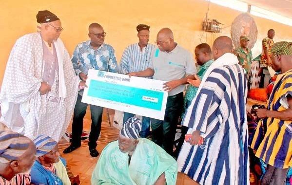 Mr Gyebi(second from left) handing over the cheque to the elders of the palace