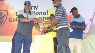 Mr Mordzifa receives his winner's prize from Mr Daniel Asare