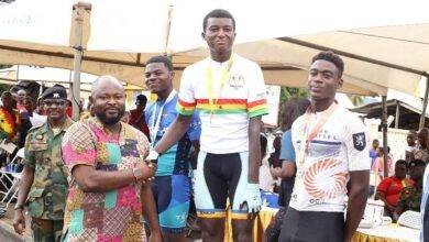 • Naba (middle) receives a handshake from Mr Riyard Mohammed after the race