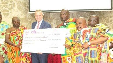 Mr Manley Gerard (fourth from right) presenting the dummy cheque to Katakyie Kwesi Bumagama II, (left),Paramount Chief of Sefwi Wiawso, Traditional Area. Photo. Ebo Gorman