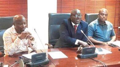 Mr Isaac Adongo (middle) addressing the media