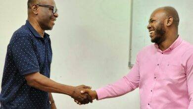 Dr Ampadu Ameyaw exchanging pleasantries with Mr Enoch Ilori after the programme