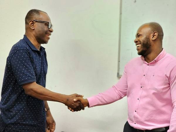 Dr Ampadu Ameyaw exchanging pleasantries with Mr Enoch Ilori after the programme