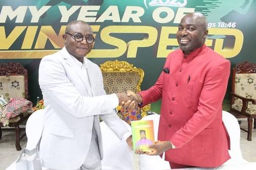 vet• Apostle Dr Robert Mensah (right) presenting an autographed book to Dr Prince Nkrumah, one of the first persons to purchase the book