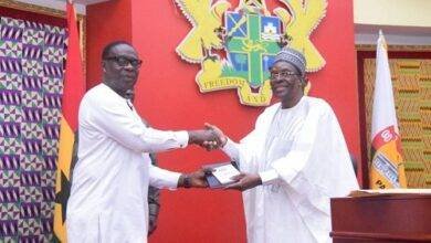 Mr Alban Bagbin (right) presenting the Constitution and the Standing Orders of the Parliament to Mr James Gyakye Quayson