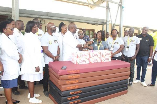 • Mrs Laryea, (fourth from right) presenting the items to Dr Brightson. With them are officials of SSO and staff of the hospital. Photo: Anita Nyarko-Yirenkyi