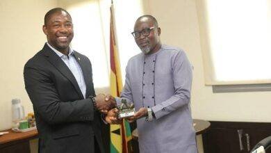Mr Osei Asibey (right) presenting a miniature trophy to Dr Okoe Boye