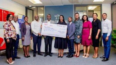 Ms Amuah (middle) presenting the dummy cheque to UNFPA Ghana
