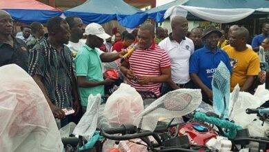 Mr Duker (right) presenting the keys to the motor cycles to Mr Anthony Donkor, Coordinator of Bonsa electoral area