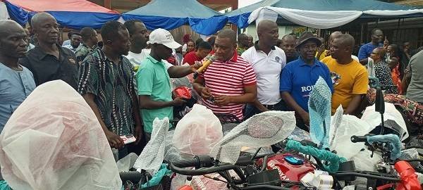 Mr Duker (right) presenting the keys to the motor cycles to Mr Anthony Donkor, Coordinator of Bonsa electoral area