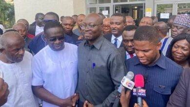 Dr Cassiel Forson (second from right) with Mr James Gyakye Quayson (second from left) and others at the court