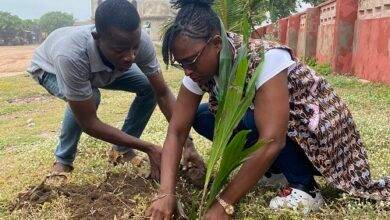 Ms Fynn (right) planting a tree and assisted by Mr Richard Owiredu