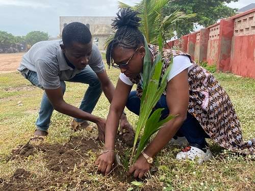 Ms Fynn (right) planting a tree and assisted by Mr Richard Owiredu