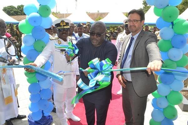 Mr Kofi Amankwa-Menu (middle) being assisted by Mr Daniel Krull (right) and Vice Admiral Seth Amoama to cut the tape for the commissioning of the school Photo Victor A. Buxton