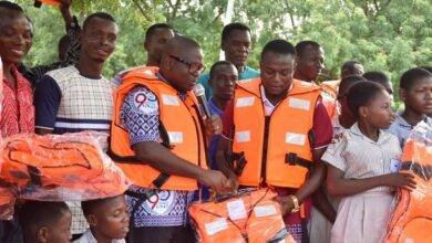 Rev Isaac Owusu, President, GNAT, handing over life jackets to teachers in Oti Region