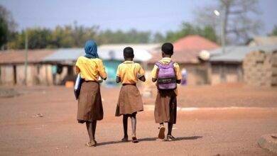 Students contemplating their journey to school Photo: Geoffrey Buta