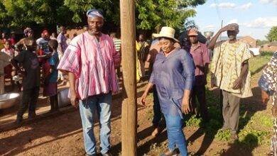 Hajia Lariba Abudu Zuwera (middle) being assisted by Mr Aremeyaw Somo Lucky Issahaku Basintale to inaugurate Baayini lights