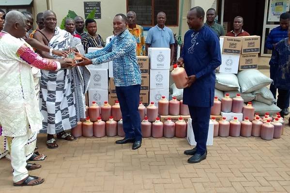 Mr Adumuah (Second from right) presenting the items to the chiefs