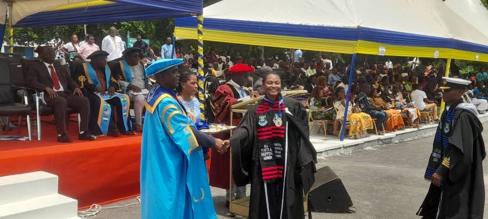 Dr Brooks (left) presenting an award to a graduate