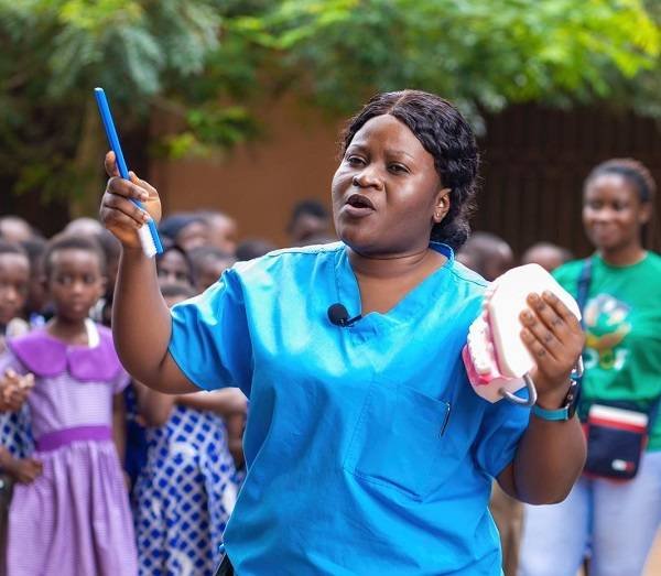 • Ms Konadu demonstrating how to rightly brush the teeth with prototype denture