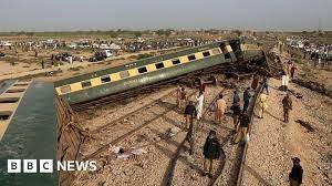 • Police officials inspect the carriages at the accident site following the derailment of the train