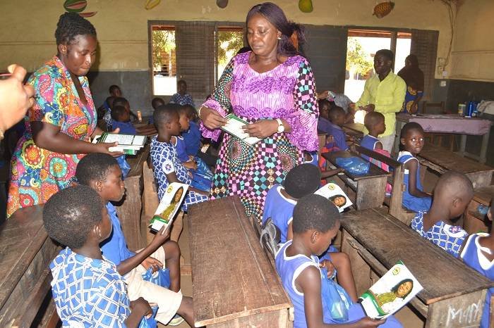 Ms Sowah (right) distributing books and other items to pupils Photo: Victor A. Buxton